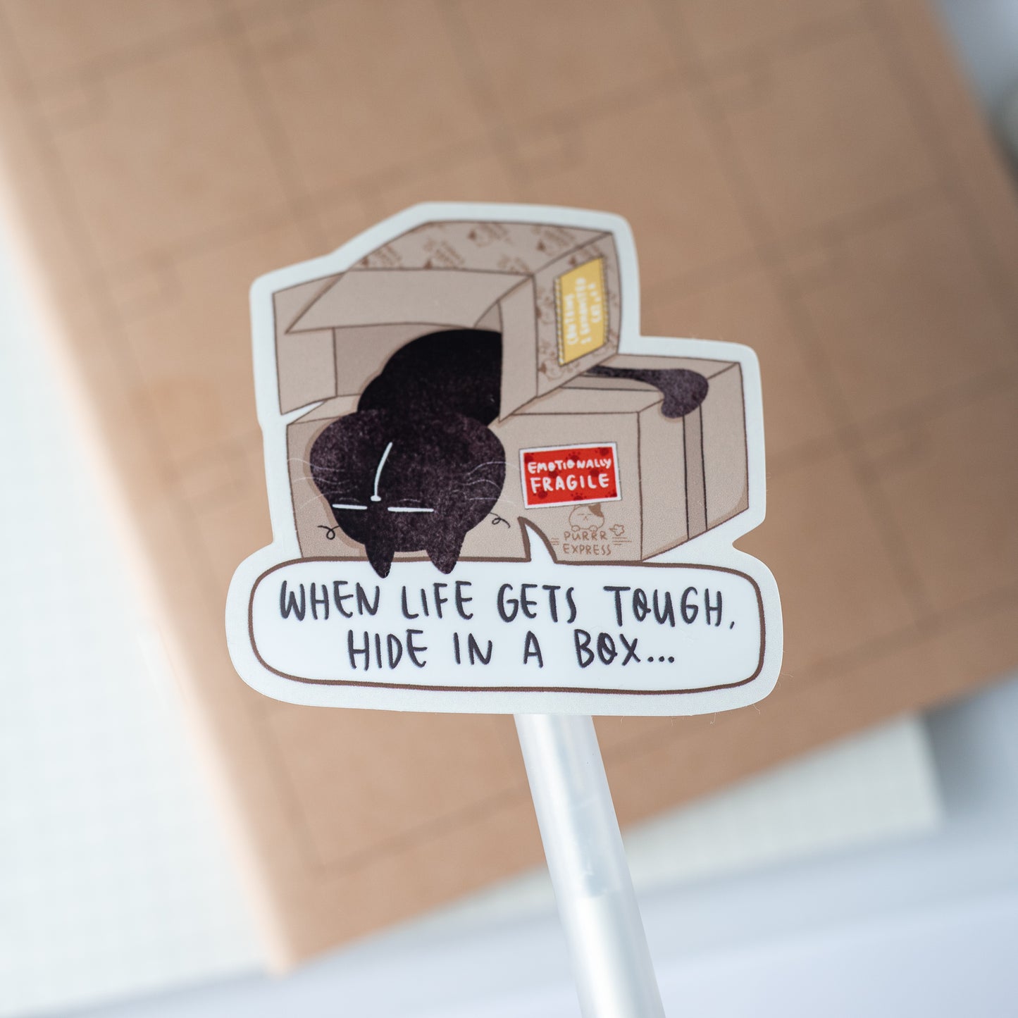 "When life gets tough, hide in a box" - Mocha Cat Motivational Vinyl Sticker